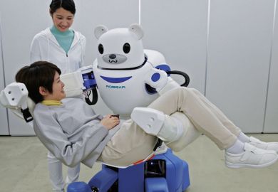 A polar bear robot "Robear" lifting a woman for a demonstration