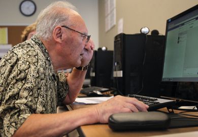 Elderly man at laptop to illustrate UK vice-chancellors staying in posts longer