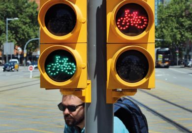 Pedestrian bicycle traffic light in Barcelona both red and green lights are on Pedestrian bicycle traffic light in Barcelona both red and green lights are on to illustrate Spanish universities law extends ‘long tradition’ of mistrust