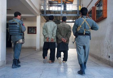 Afghan policemen escort two suspected Taliban in Herat to illustrate ‘I was beaten daily’: Afghan scholar recounts Taliban torture