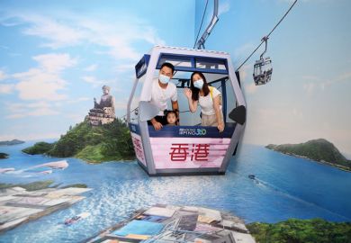 : Visitors pose for photos with a 3D art installation during an exhibition to illustrate China’s promised research reform ‘little more than PR exercise’