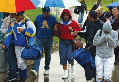 Spectators exit the Woodbridge Softball Classic Tournament which was postponed.