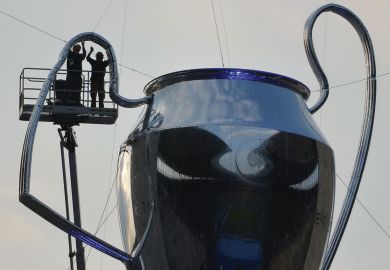 Men working on a giant inflatable trophy.