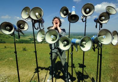 Composer and director of The Shout choir surrounded by megaphones on Devils Dyke, Sussex Composer and director of The Shout choir surrounded by megaphones on Devils Dyke, Sussex to illustrate Student complaints hit new record levels in England and Wales