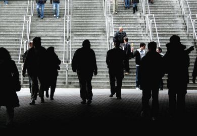 Silhouette of crowd walking towards stairs as a metaphor for more European staff leaving UK for universities abroad post-Brexit