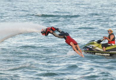 Person dives into the water on a flyboard at the Detroit river front Person dives into the water on a flyboard at the Detroit river front