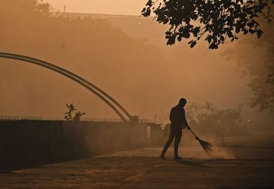 A sweeper cleans a Street early morning in Mumbai  A sweeper cleans a Street early morning in Mumbai to illustrate Scholars fear push for Indian universities to teach in Hindi