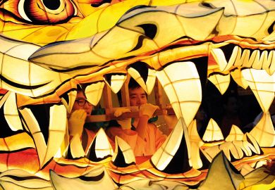 Men are pictured inside the mouth of a float as South Korean Buddhists parade to illustrate Low-scoring students penalise instructors despite grade inflation