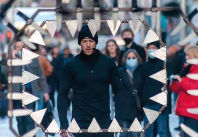 Stunt runner runs and jumps through metalwork surrounded by knives to illustrate Post-92 contract ‘at risk’ in wave of university cost-cutting