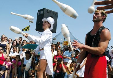 Jugglers perform during Circus Days at Coney Island in the Brooklyn borough of New York City to illustrate Remedial education gets big overhaul in US