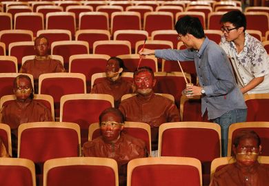 Liu, the Chinese artist known as "the invisible man" for using painted-on camouflage to blend into the backdrops of his photographs, has done it again by making himself and other participants "disappear" into the red seats of a Beijing theatre. Liu, the Chinese artist known as "the invisible man" for using painted-on camouflage to blend into the backdrops of his photographs, has done it again to illustrate UK universities are self-harming by exploiting Chinese students