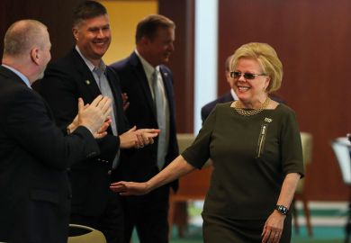 University of South Florida president elect Rhea Law enters the room to applauds and cheers as she is named the new university president as described in the article