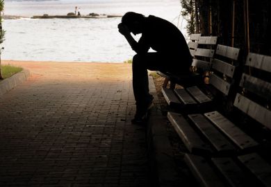 Silhouette of person sitting on a bench Silhouette of person sitting on a bench as a metaphor for The burned-out suffer in silence