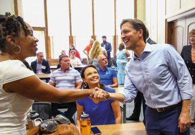 Erica McCray, associate dean meets Ben Sasse, president of the University of Florida to illustrate Ben Sasse wins over Florida faculty with moderation and money