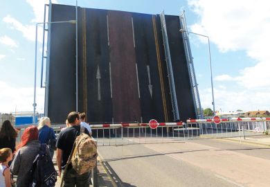 Bridge raised with gates and people waiting to cross ridge raised with gates and people waiting to cross as a metaphor for Overseas research cuts threaten UK’s ‘levelling-up’ agenda.