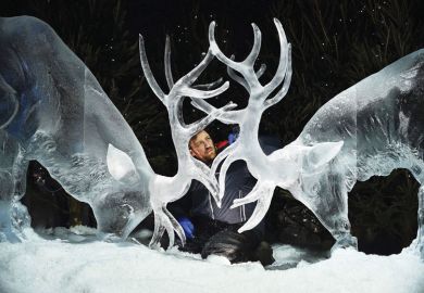 man looking at ice sculpture of two stags with horns together as a metaphor for ‘Nordic’ innovation vision for Scotland backs university mergers.