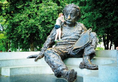Person talking in the ear of the Einstein memorial inWashington D.C. Person talking in the ear of the Einstein memorial inWashington D.C. to illustrate ‘Don’t fear’ waking giant of international education