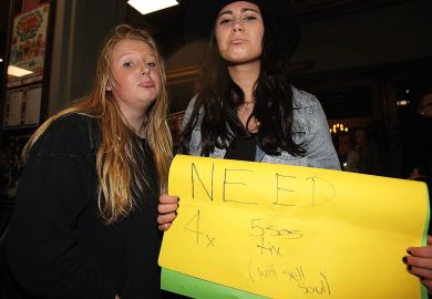 Young fans try to buy tickets for the sold out show to illustrate Australia wrestles with shortage of placements for students