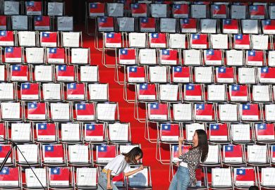 Two people in front of empty seating in Taiwan to illustrate Scholars doubtful of Taiwan’s international student target