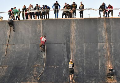 People climbing ropes during the Race of Heroes obstacle course race