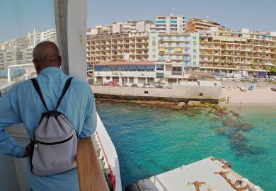 Man standing on ferry looking at Messina city skyline to illustrate Italy turns hotels into student halls to battle demographic decline