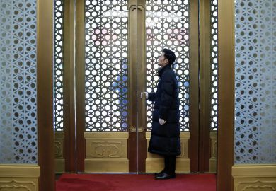 Security personnel stands behind a gate in Beijing, China to illustrate Fears for academia’s ‘peacemaker’ role, as China expertise wanes 