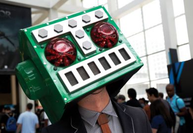   A man in a Destructoid costume on his head as Stanford students sour on big tech careers amid ethics concerns