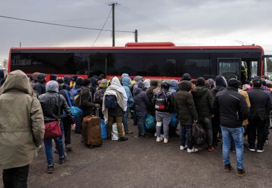 People gather to take a bus as refugees from many countries including India - mostly students of Ukrainian universities are seen at the Medyka pedestrian border crossing fleeing the conflict in Ukraine