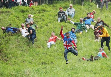 People taking part in the Cheese-Rolling downhill race in Gloucester, England to illustrate Entry rate fall creates ‘strategic uncertainty’ in English sector