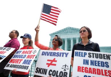 Protesters hold signs as demonstrators for and against the U.S. Supreme Court decision to strike down race-conscious student admissions programs at Harvard University and the University of North Carolina confront each other, in Washington