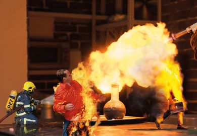 Lab technician setting fire to a ball with a hydrogen blowtorch to illustrate Can the REF really address the research environment crisis?