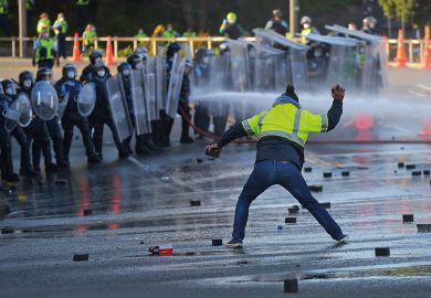 A man faces off with police near the parliament as police move in to clear protesters in Wellington to illustrate We need support as threats worsen, says scholar who sued Auckland