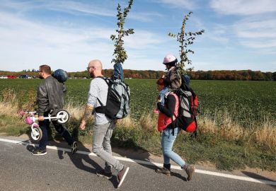three adults and one child walking