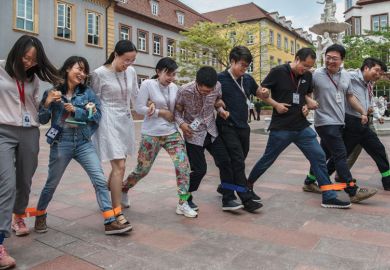 Huawei workers play a 'team building' game at the end of the lunch break at the new sprawling 'Ox Horn' Research and Development campus 