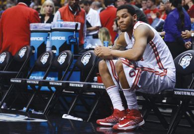 Amir Williams f the Ohio State Buckeyes sits on the bench by himself after losing  NCAA Men's Basketball Tournament 