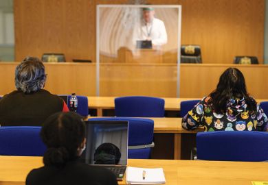 ecturer Ian Bowden teaches law students wearing face coverings to help mitigate the spread of the novel coronavirus . ecturer Ian Bowden teaches law students wearing face coverings to help mitigate the spread of the novel coronavirus .
