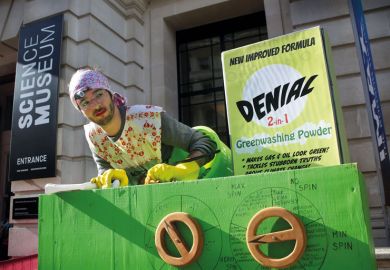 A protester dressed as a scrubber puts denial powder into the giant greenwashing washing machine during an extinction rebellion protest to illustrate Climate scientists fear loss of policy influence under Rees-Mogg