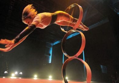 Girl jumps threw hoop at circus 