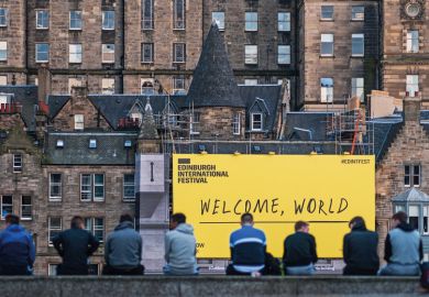 EDINBURGH, SCOTLAND - AUGUST 14: Citizen stand in front of the welcome sign of Edinburgh Festival Fringe on August 14, 2016 in Edinburgh, Scotland.