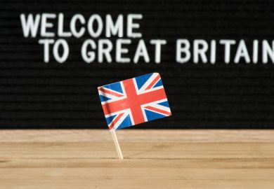 A flag with a sign behind it saying 'Welcome to Great Britain' A flag with a sign behind it saying 'Welcome to Great Britain'