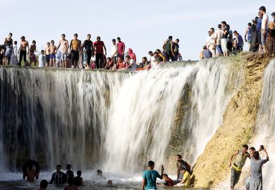 Egyptians enjoy a waterfall in Wadi El-Rayan