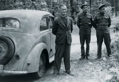 William Joyce (Lord Haw-Haw) guarded by soldiers, Germany, 1945