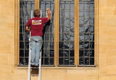 Man cleans the windows of the Bodleian Library