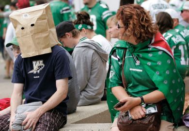 Winnipeg Blue Bomber fan hides head in paper bag Winnipeg Blue Bomber fan hides head in paper bag