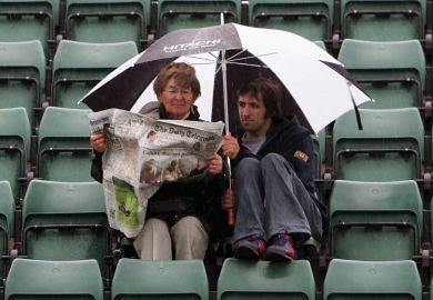 Woman and man read paper in rain