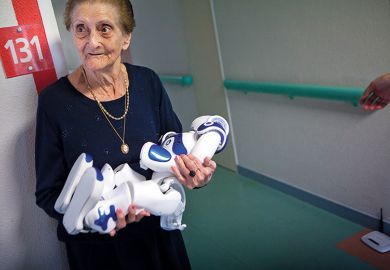 elderly woman holding robot