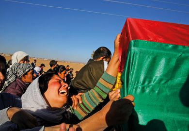 Woman grieving at funeral with coffin