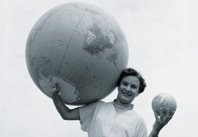 Woman holding large and small globes