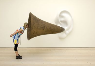 Woman looking into ear trumpet