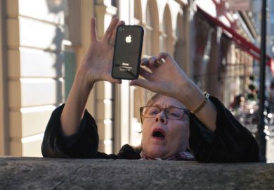 Woman taking photo using Apple iPhone smartphone